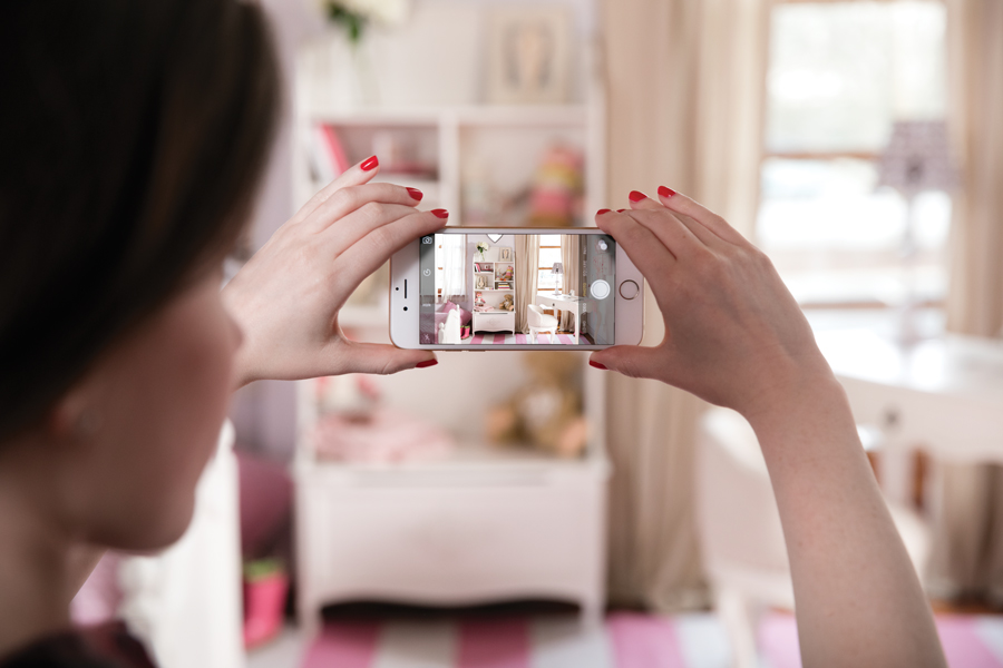 Teen taking iphone photo of room
